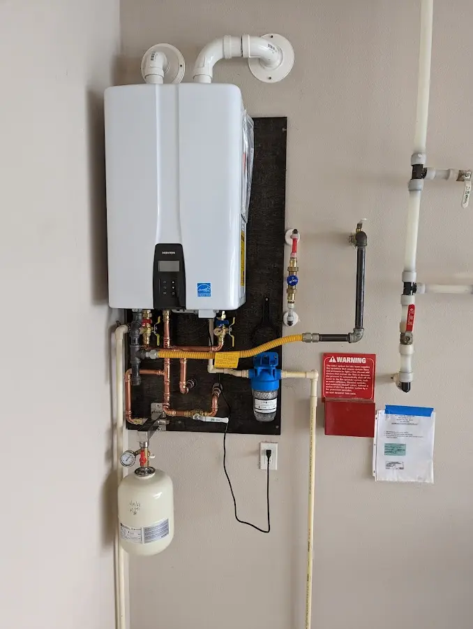 Professional plumber installing copper piping in a Alturas home